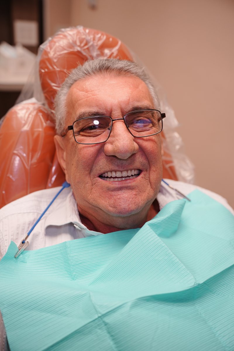 Same patient after implant-supported dentures at Imaging Dentistry with a brand new smile
