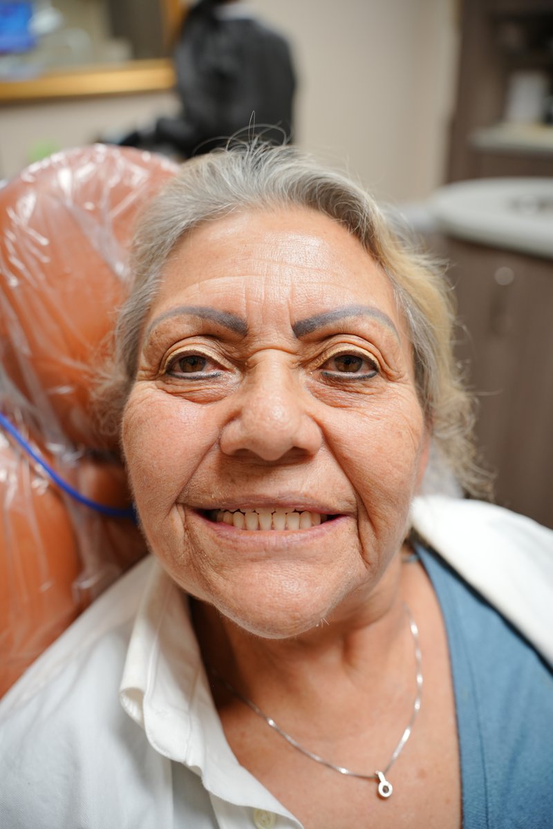Another happy Imaging Dentistry patient with her new smile after implant-supported dentures